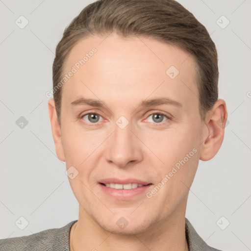 Joyful white young-adult male with short  brown hair and grey eyes