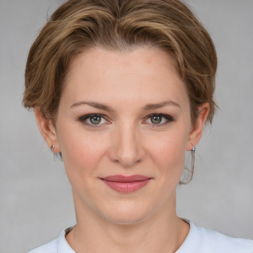 Joyful white young-adult female with medium  brown hair and blue eyes