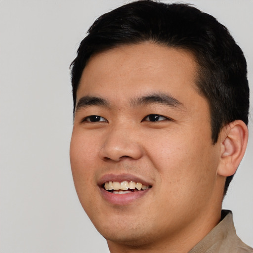 Joyful asian young-adult male with short  black hair and brown eyes