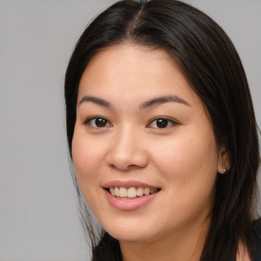 Joyful asian young-adult female with long  brown hair and brown eyes