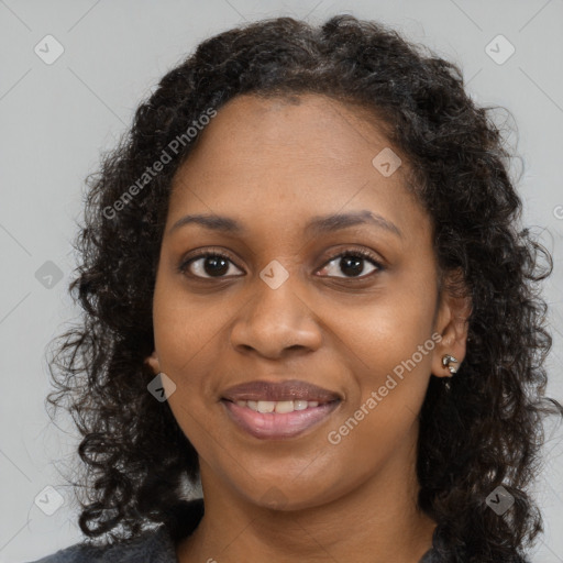 Joyful black young-adult female with long  brown hair and brown eyes