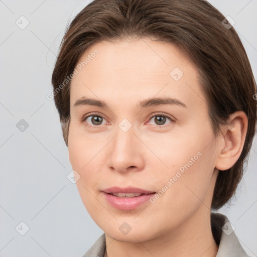 Joyful white young-adult female with medium  brown hair and grey eyes