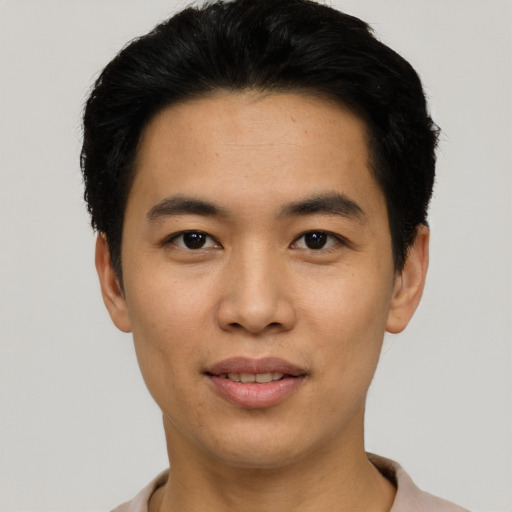 Joyful asian young-adult male with short  black hair and brown eyes