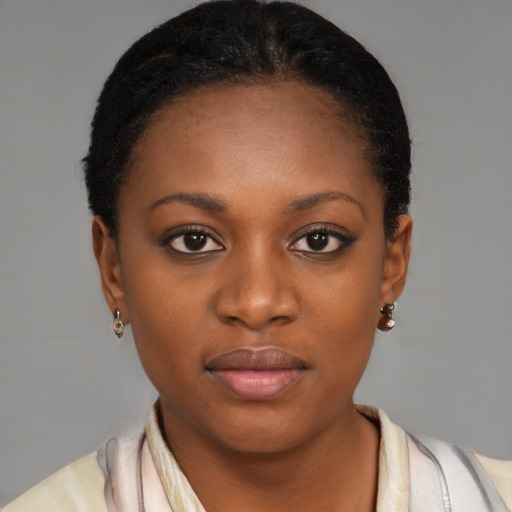 Joyful black young-adult female with short  black hair and brown eyes