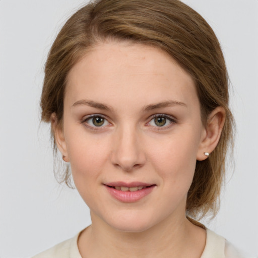 Joyful white young-adult female with medium  brown hair and green eyes