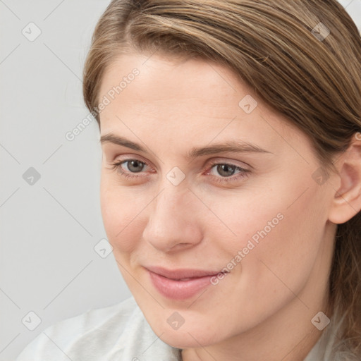 Joyful white young-adult female with medium  brown hair and grey eyes