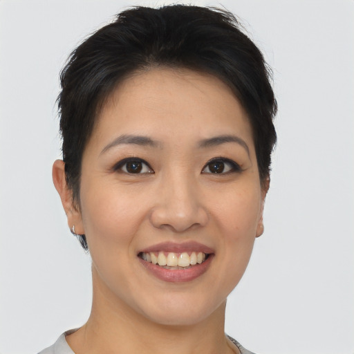 Joyful asian young-adult female with short  black hair and brown eyes