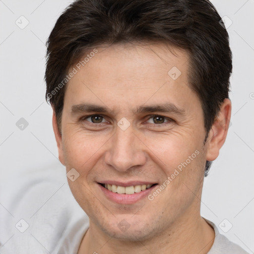 Joyful white adult male with short  brown hair and brown eyes