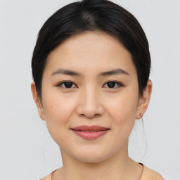 Joyful asian young-adult female with medium  brown hair and brown eyes