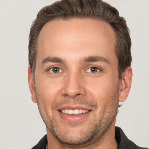 Joyful white young-adult male with short  brown hair and brown eyes