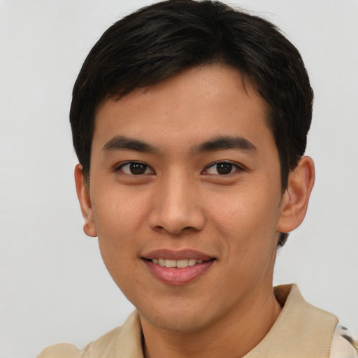Joyful asian young-adult male with short  brown hair and brown eyes