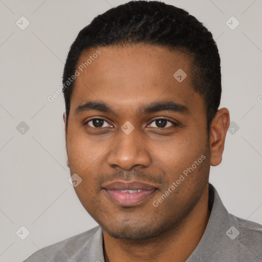 Joyful black young-adult male with short  black hair and brown eyes