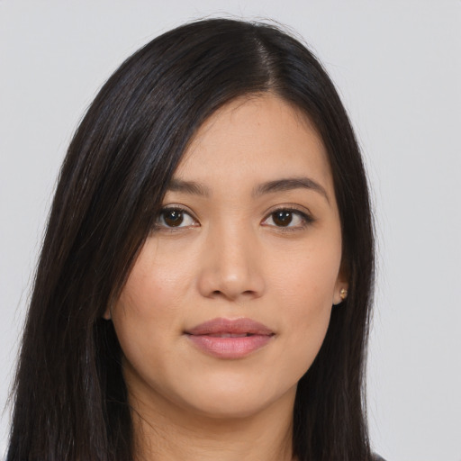 Joyful asian young-adult female with long  brown hair and brown eyes