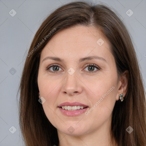 Joyful white adult female with long  brown hair and brown eyes