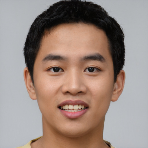 Joyful asian young-adult male with short  black hair and brown eyes