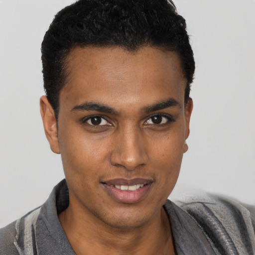 Joyful black young-adult male with short  black hair and brown eyes
