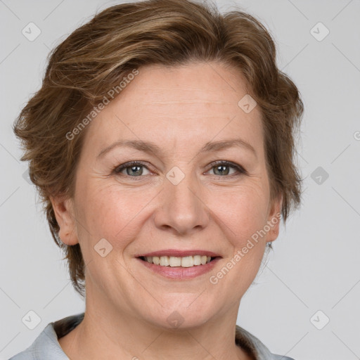 Joyful white adult female with medium  brown hair and grey eyes