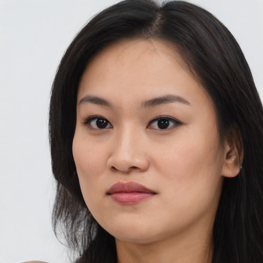 Joyful asian young-adult female with long  brown hair and brown eyes