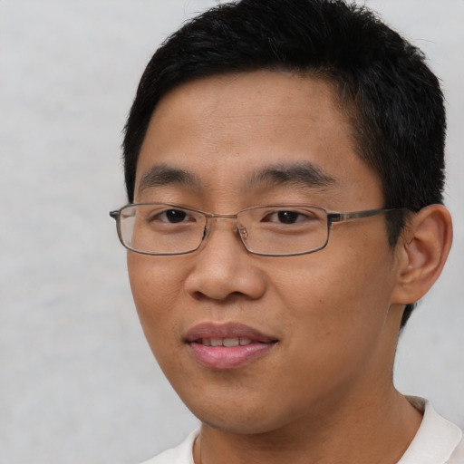 Joyful asian young-adult male with short  brown hair and brown eyes