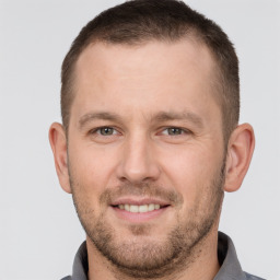 Joyful white young-adult male with short  brown hair and brown eyes