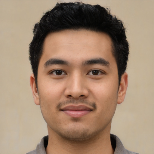 Joyful asian young-adult male with short  black hair and brown eyes