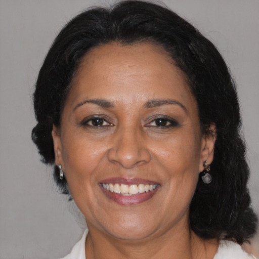 Joyful black adult female with medium  brown hair and brown eyes