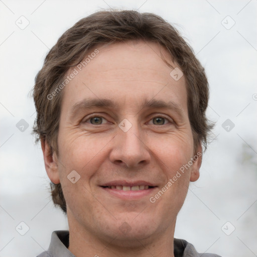 Joyful white adult male with short  brown hair and grey eyes