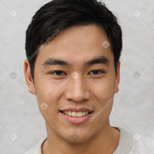 Joyful asian young-adult male with short  black hair and brown eyes