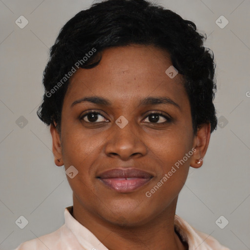 Joyful black young-adult female with short  black hair and brown eyes