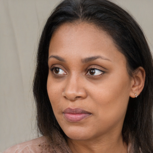 Joyful black young-adult female with long  brown hair and brown eyes