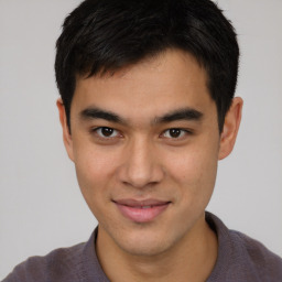 Joyful latino young-adult male with short  brown hair and brown eyes