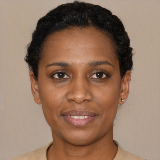 Joyful latino young-adult female with short  black hair and brown eyes