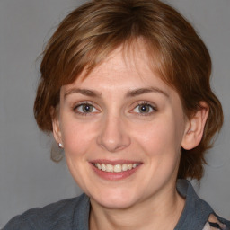 Joyful white adult female with medium  brown hair and blue eyes