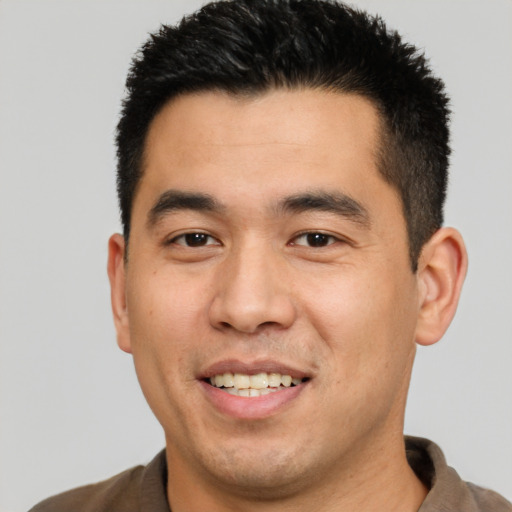 Joyful white young-adult male with short  black hair and brown eyes