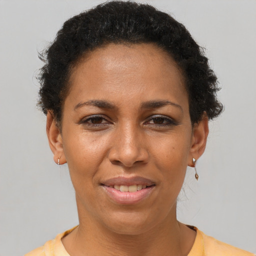Joyful latino adult female with short  brown hair and brown eyes