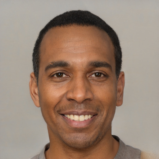 Joyful latino adult male with short  black hair and brown eyes