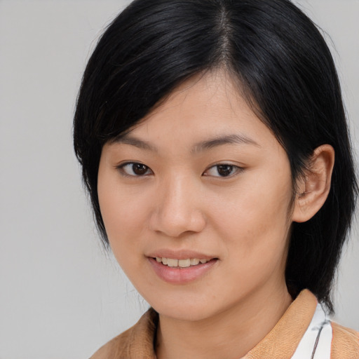Joyful asian young-adult female with long  black hair and brown eyes