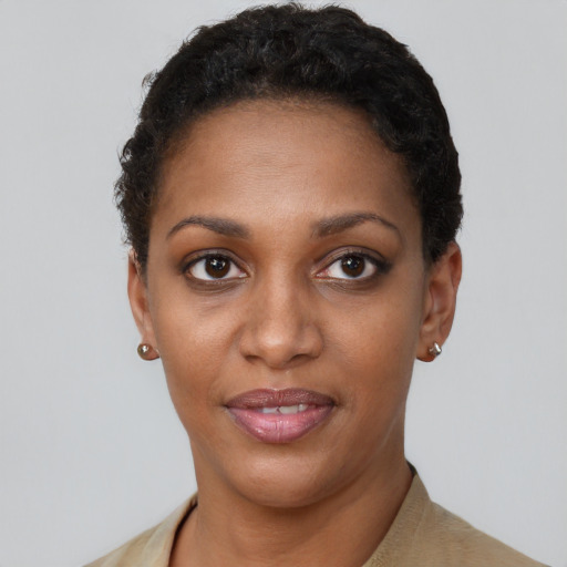 Joyful black young-adult female with short  brown hair and brown eyes
