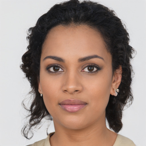 Joyful latino young-adult female with long  brown hair and brown eyes