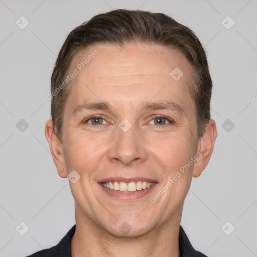 Joyful white adult male with short  brown hair and brown eyes