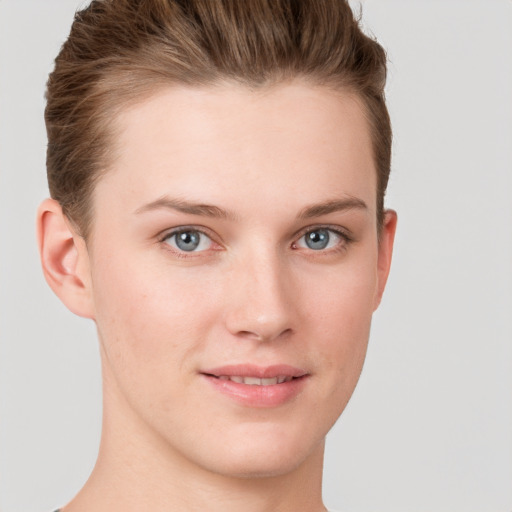 Joyful white young-adult female with short  brown hair and grey eyes