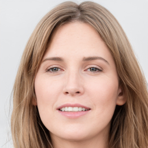 Joyful white young-adult female with long  brown hair and grey eyes