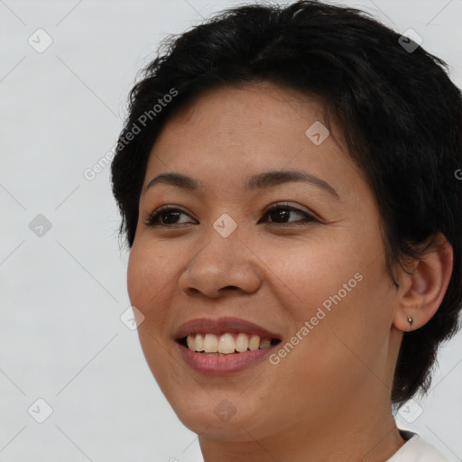 Joyful asian young-adult female with short  brown hair and brown eyes