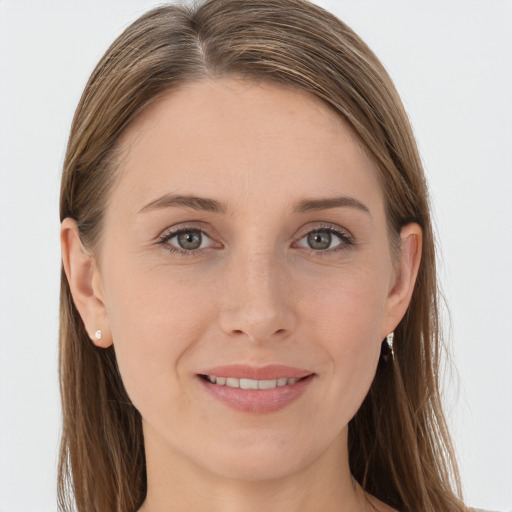 Joyful white young-adult female with long  brown hair and grey eyes