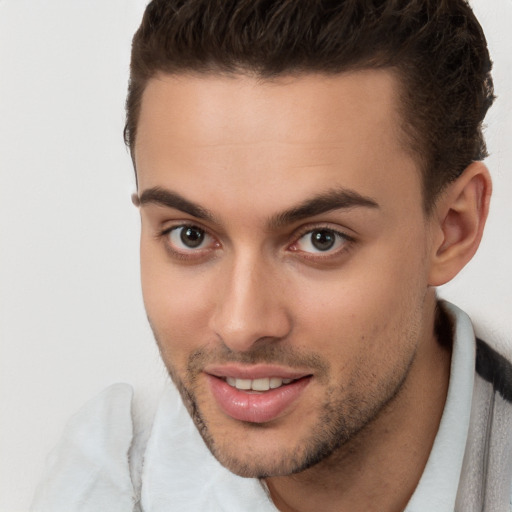 Joyful white young-adult male with short  brown hair and brown eyes