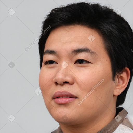 Joyful asian young-adult male with short  black hair and brown eyes