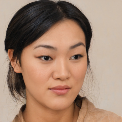 Joyful asian young-adult female with medium  brown hair and brown eyes