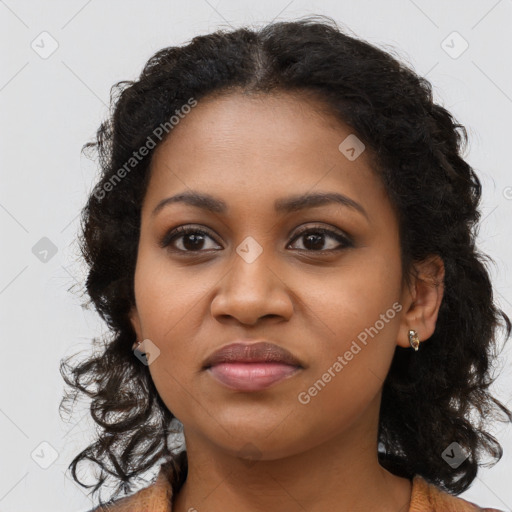 Joyful black young-adult female with long  brown hair and brown eyes