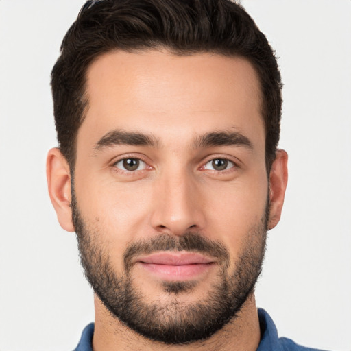 Joyful white young-adult male with short  brown hair and brown eyes