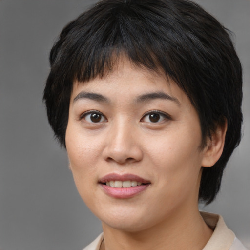 Joyful asian young-adult female with medium  brown hair and brown eyes